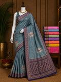 Slate blue boutique saree with floral medallions and navy gold-tone border