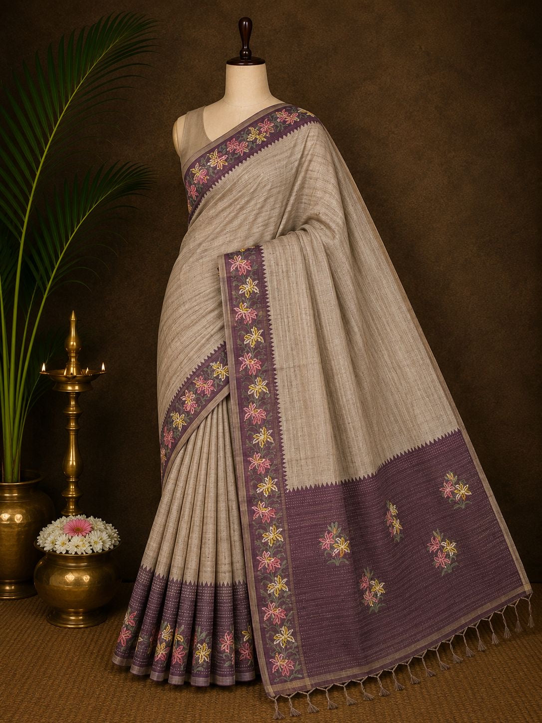 Beige party wear saree with plum floral border and pallu