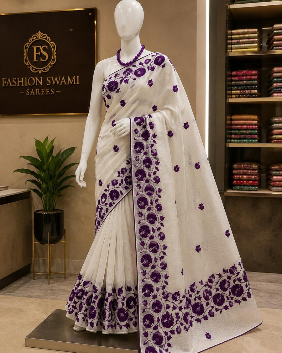 Ivory party wear saree with rich purple floral border and scattered blossoms