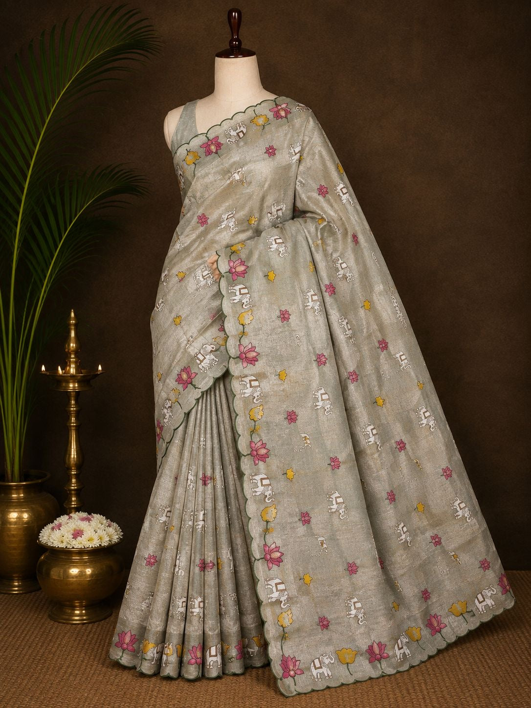 Silver grey party wear saree with lotus and elephant motifs